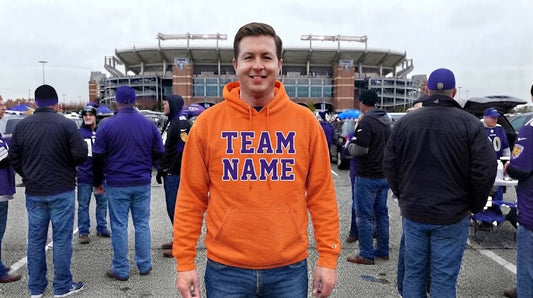 Fan in Baltimore Ravens Orange Hoodie Outside Stadium